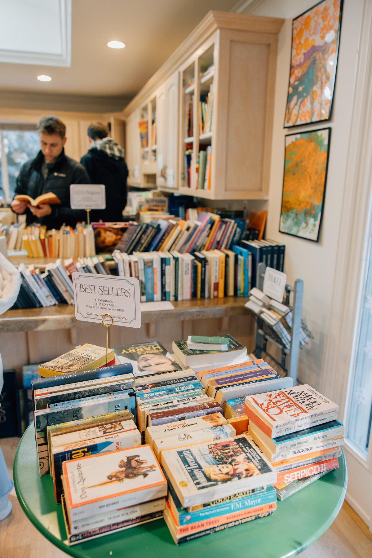 A table of second hand books marked Best Sellers inside the library