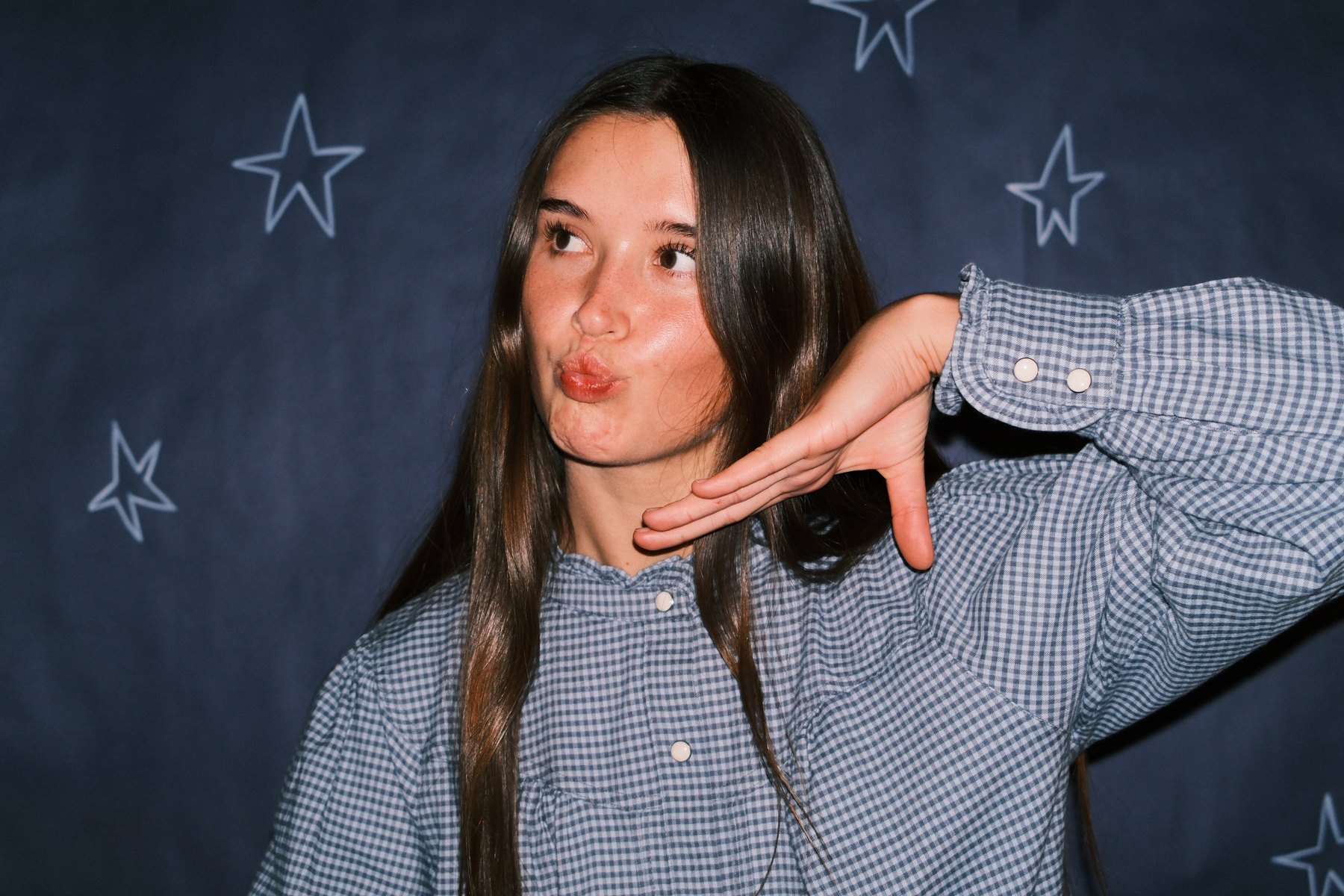 Bailey Nye in front of a navy backdrop painted with stars